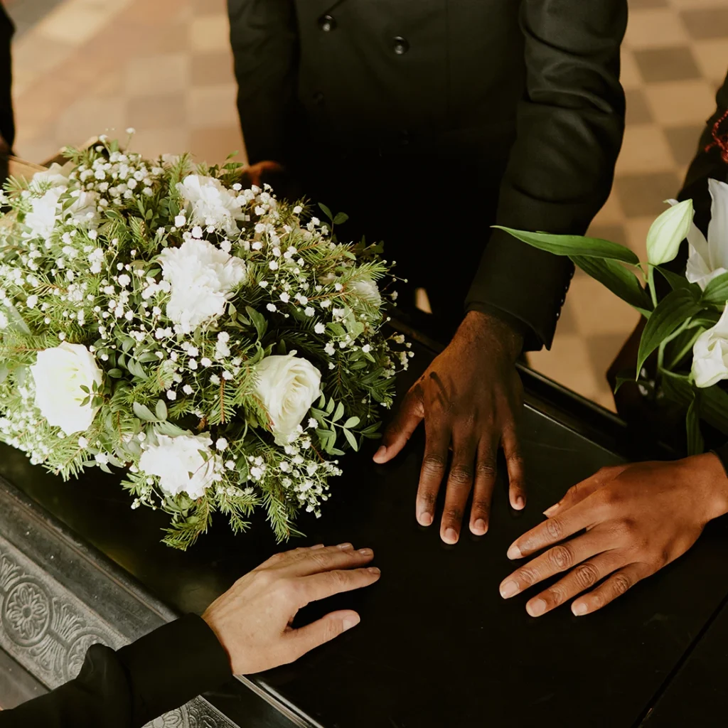 Hands holding flowers representing loss and wrongful death claim in Michigan.